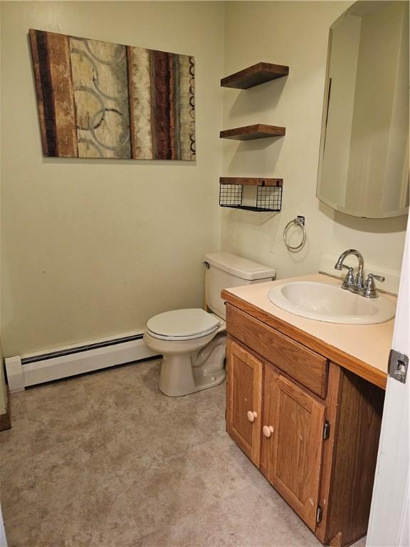 bathroom featuring vanity, a baseboard radiator, and toilet