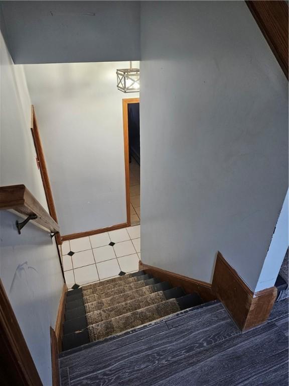 stairway with tile patterned floors