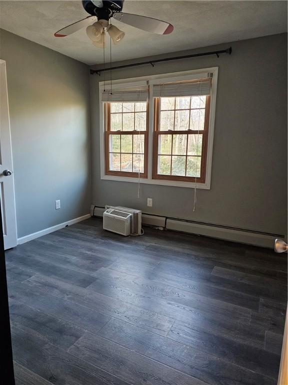 unfurnished room with a baseboard radiator, ceiling fan, and dark hardwood / wood-style floors