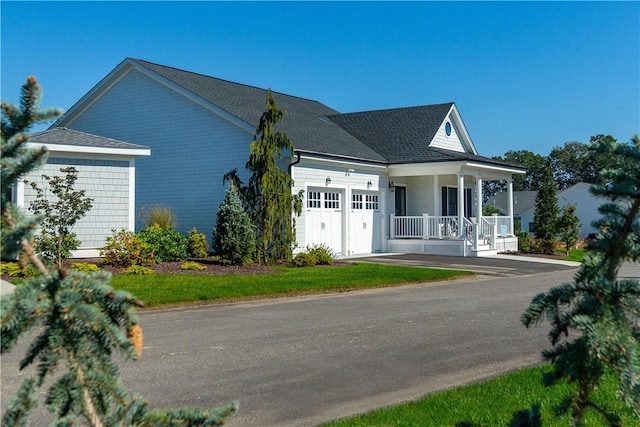 view of front of home featuring covered porch and a garage