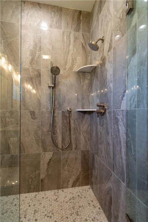 bathroom with tiled shower