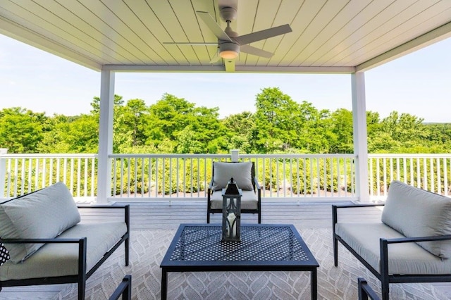 deck featuring ceiling fan and an outdoor living space