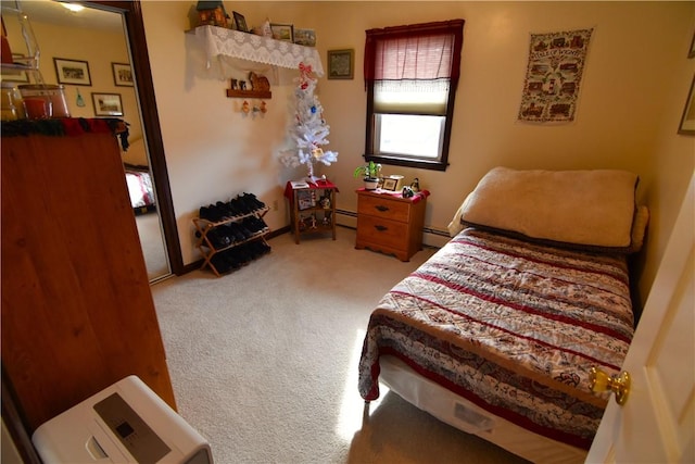 bedroom featuring a baseboard heating unit and carpet flooring