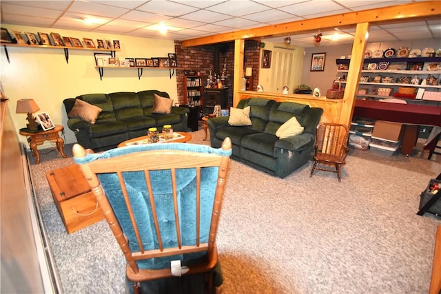 living room with a paneled ceiling and carpet flooring