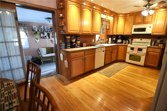 kitchen with white appliances, ceiling fan, light wood-type flooring, and sink