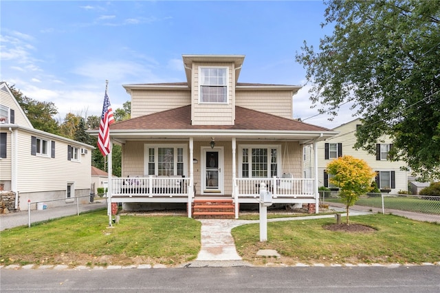 view of front of home with a porch and a front yard