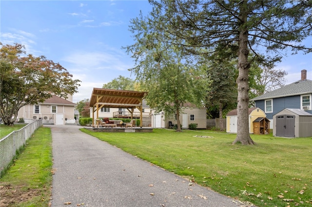 view of front of house featuring a gazebo, a front lawn, and a shed