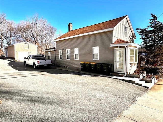 view of front of house featuring an outdoor structure and a garage