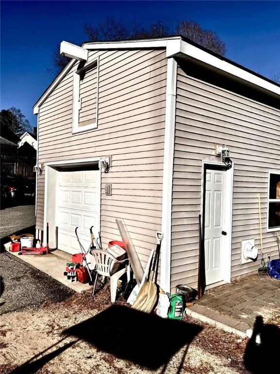 rear view of property featuring a garage