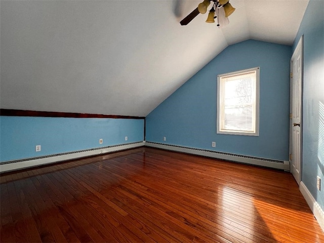 additional living space with hardwood / wood-style flooring, baseboard heating, and lofted ceiling