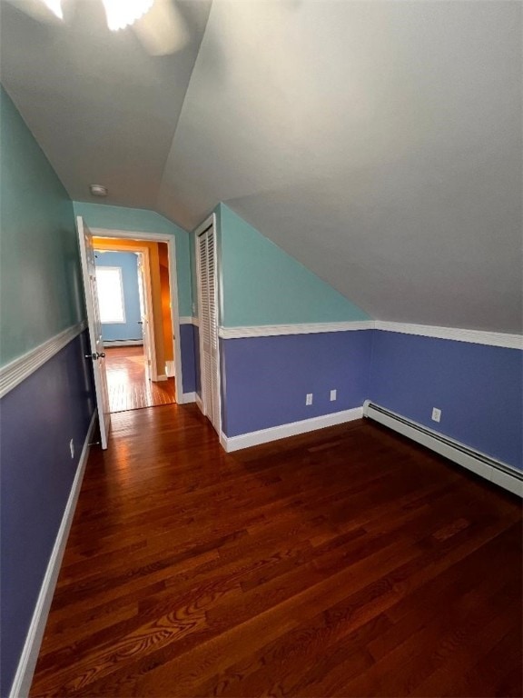 additional living space featuring ceiling fan, lofted ceiling, and dark hardwood / wood-style floors