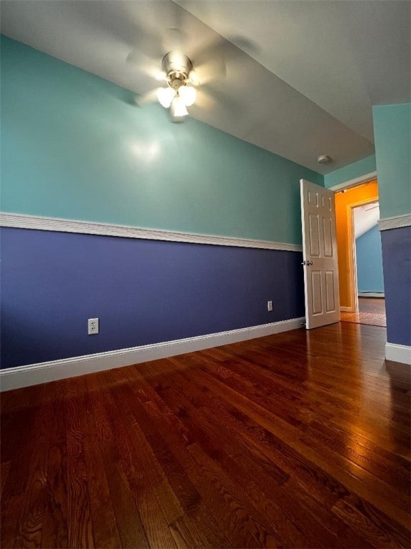 unfurnished room featuring ceiling fan, dark hardwood / wood-style flooring, and lofted ceiling