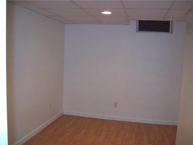 unfurnished room featuring a drop ceiling and hardwood / wood-style floors