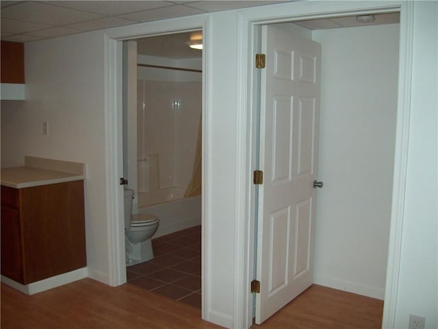 bathroom with toilet, tub / shower combination, and hardwood / wood-style flooring