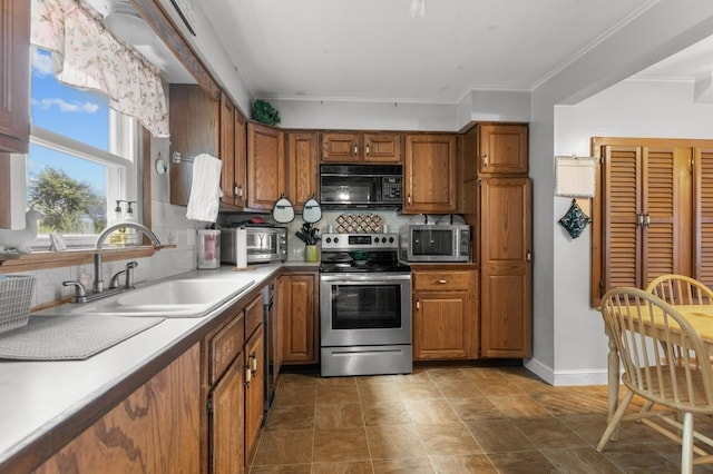 kitchen with sink, backsplash, crown molding, and stainless steel appliances