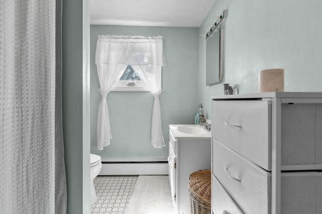 full bath featuring vanity, a baseboard heating unit, and toilet