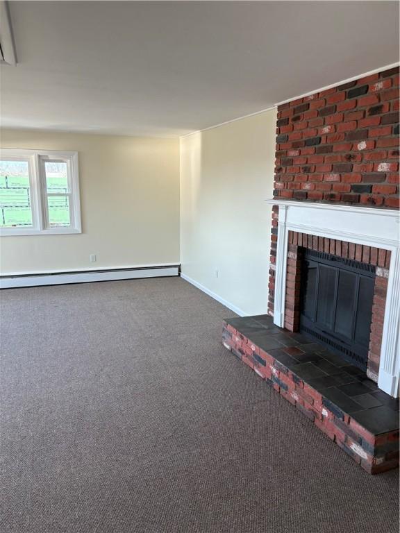 unfurnished living room with baseboards, a baseboard radiator, carpet, and a brick fireplace