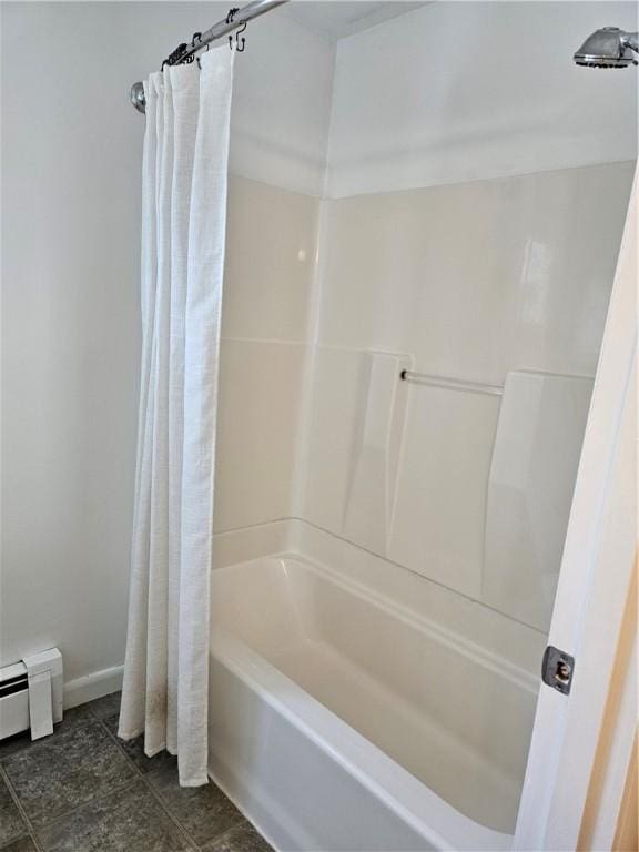 bathroom featuring baseboards and shower / bath combo