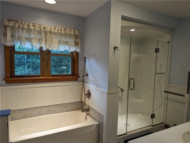 bathroom featuring vanity and independent shower and bath