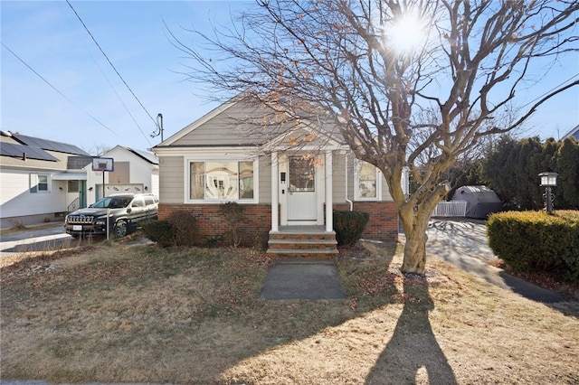 bungalow-style house with a front lawn