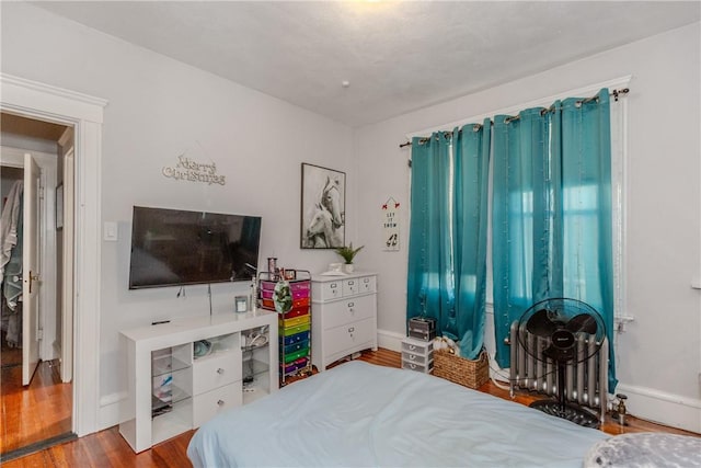 bedroom with hardwood / wood-style floors