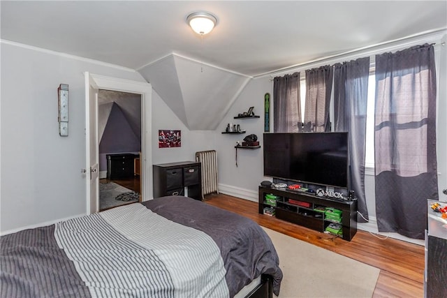 bedroom featuring lofted ceiling and hardwood / wood-style floors