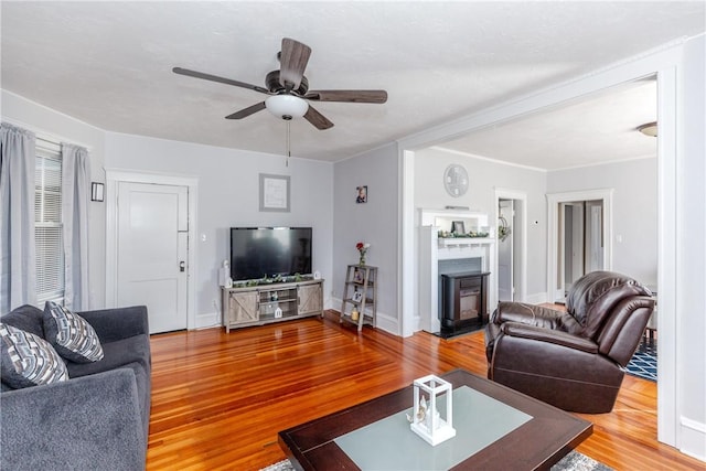 living room with hardwood / wood-style flooring and ceiling fan