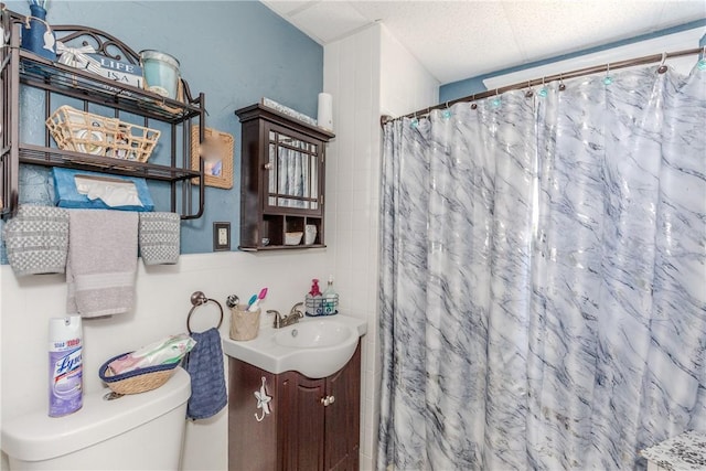 bathroom featuring toilet, vanity, and curtained shower