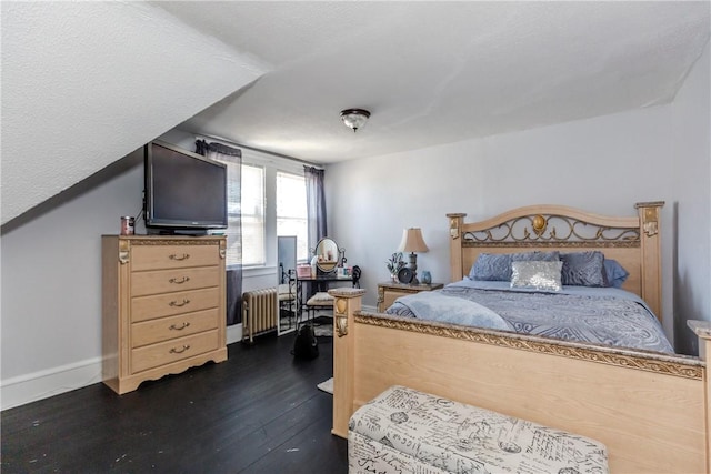 bedroom featuring radiator and dark hardwood / wood-style flooring