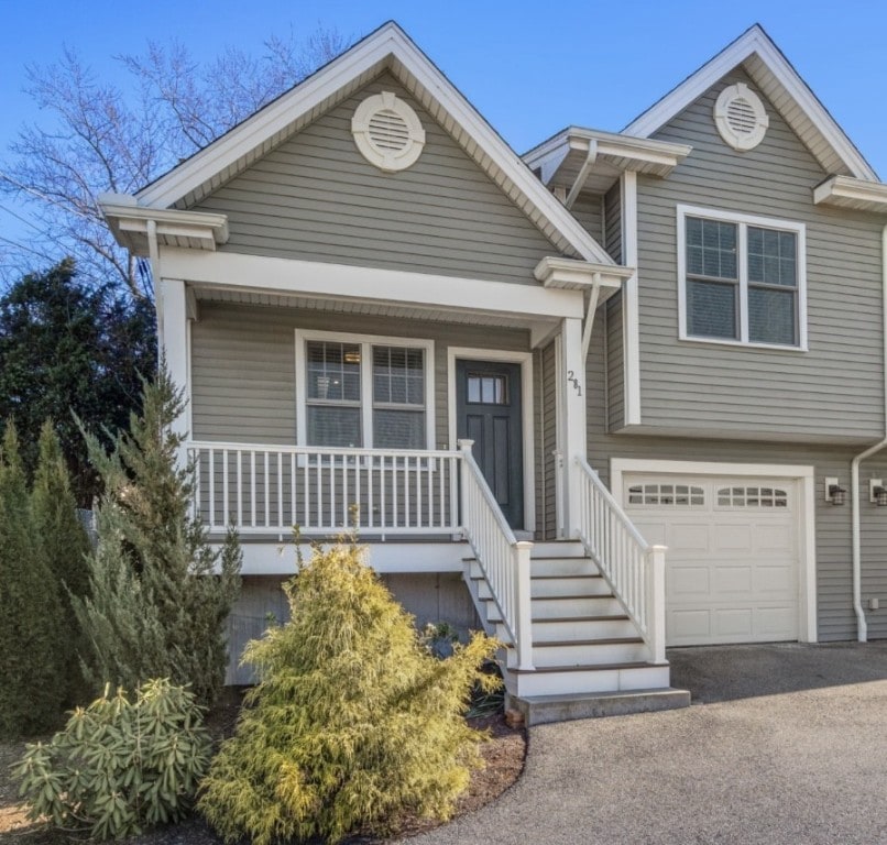 view of front of home with covered porch and a garage