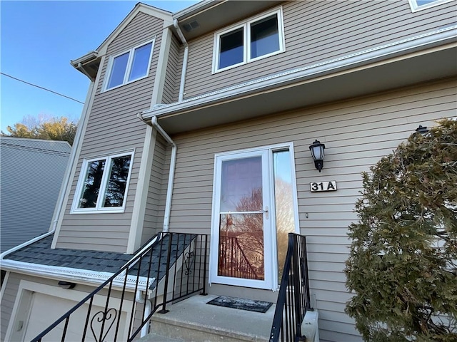 view of exterior entry featuring a garage