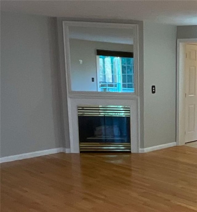 unfurnished living room featuring hardwood / wood-style flooring