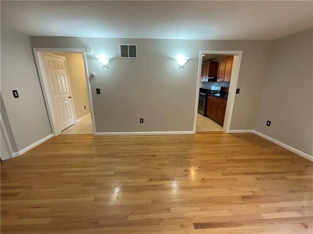 unfurnished room featuring light hardwood / wood-style floors