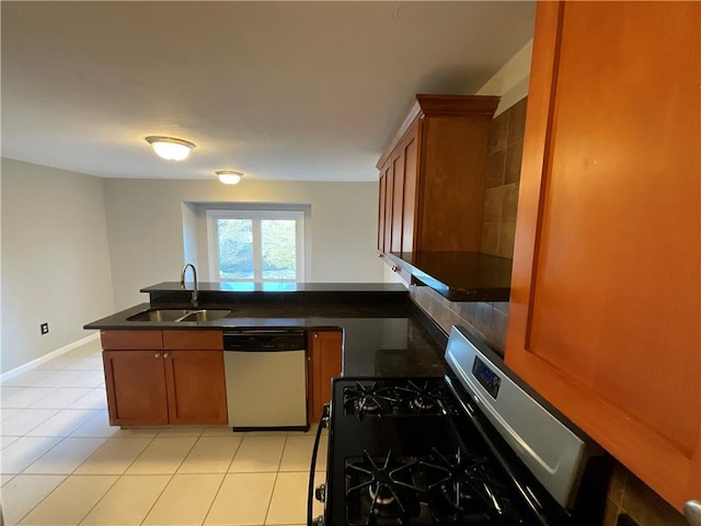 kitchen featuring sink, light tile patterned floors, and stainless steel appliances