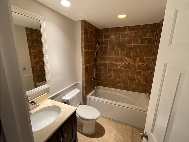 full bathroom with toilet, vanity, tile patterned flooring, and tiled shower / bath