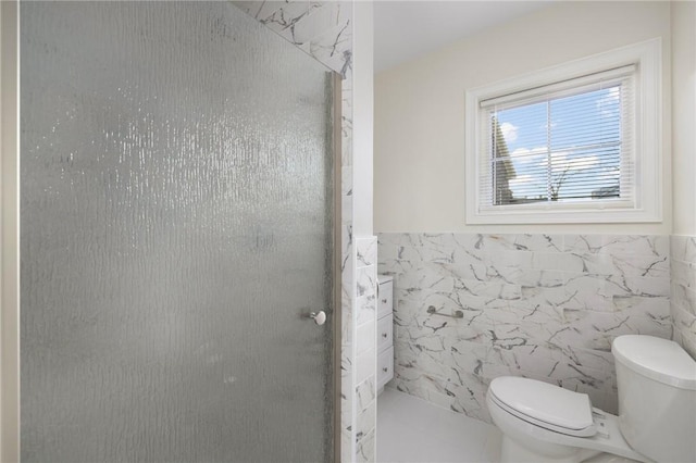 bathroom with walk in shower, tile walls, and toilet