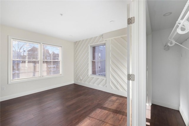 empty room featuring dark hardwood / wood-style flooring