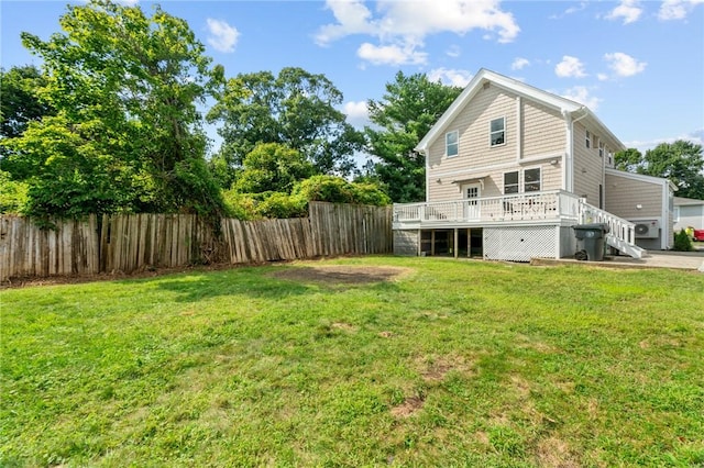 back of property with a deck and a yard