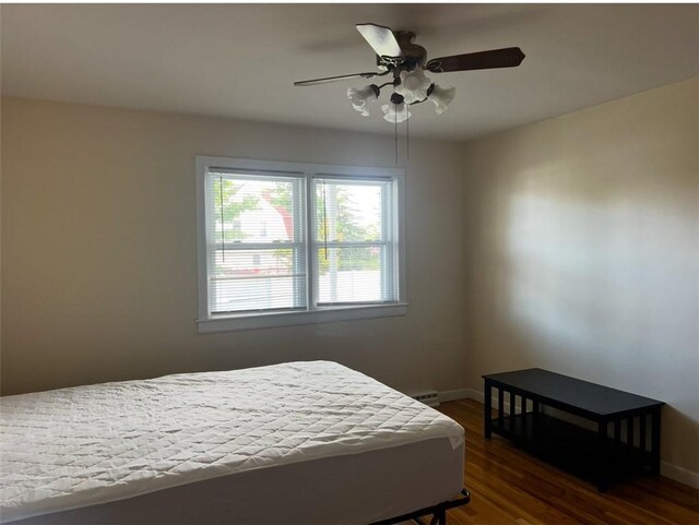 bedroom with ceiling fan and dark hardwood / wood-style flooring