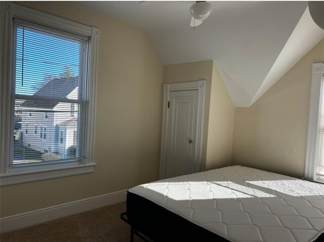 bedroom featuring ceiling fan, vaulted ceiling, and carpet floors