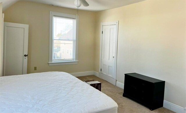 bedroom with ceiling fan and light carpet