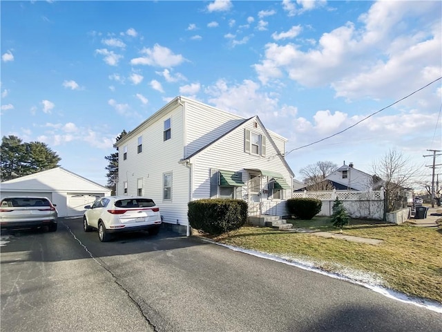 view of home's exterior with a garage and a lawn