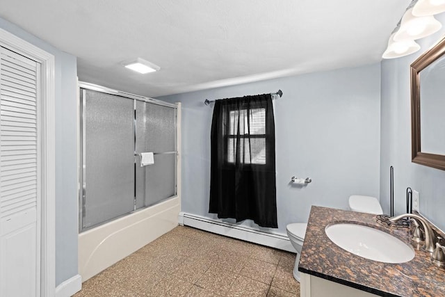 full bathroom featuring vanity, a baseboard radiator, combined bath / shower with glass door, and toilet