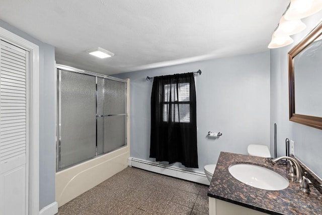 full bathroom with a baseboard radiator, combined bath / shower with glass door, vanity, and toilet