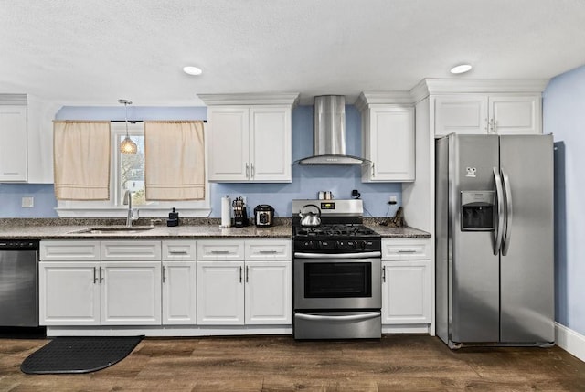 kitchen with dark hardwood / wood-style floors, sink, white cabinets, stainless steel appliances, and wall chimney range hood