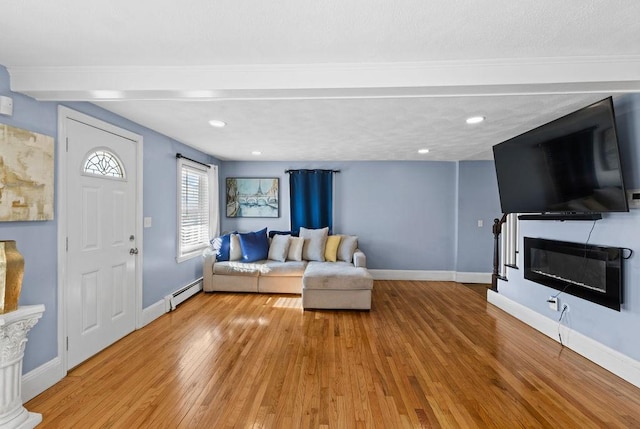 living room with light hardwood / wood-style flooring and a baseboard radiator