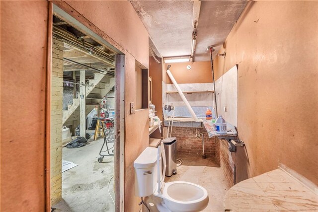 bathroom with toilet and concrete floors