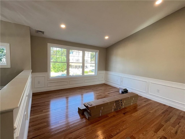 empty room with dark hardwood / wood-style flooring