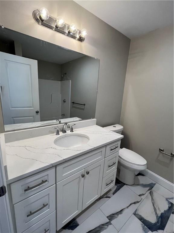 bathroom featuring walk in shower, vanity, and toilet