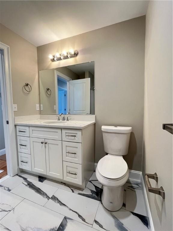 bathroom featuring toilet and vanity